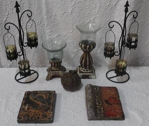 lot 231 image: Candle holders and a couple Stone tablet decorated wall art and a metal pumpkin trinket box