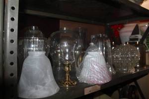 lot 498 image: Shelf full of glass light fixtures