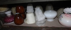 lot 499 image: Shelf full of glass light fixtures