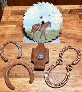 lot 89 image: AntiqueVintage Horse Shoes, Sawblade Art &amp State of Texas Employee Walkie Talkie Holster