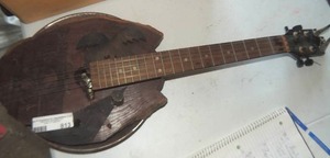 lot 813 image: BANJO - CONSTRUCTED OF A WOOD SLICE PIE PAN &  HORNS