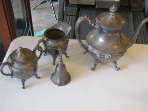 lot 54 image: silver plate lot, handled tea pot, creamer and sugar dish and a bell