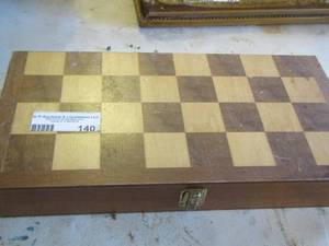 lot 140 image: checkered board with pieces inside and book on how to play