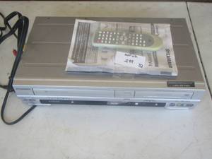 lot 352 image: Sylvania dvd and vhs player with paper work and remote
