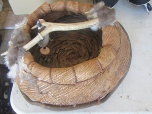 lot 553 image: bark basket  w antler across the top with fur wrapped around both ends