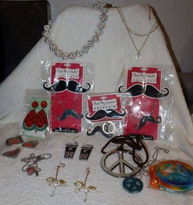 lot 56 image: Novelty Jewelry dice necklace, Flash My Stache items, Glass carousel horse earrings, Peace sign and  watermelon jewelry