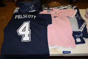 lot 44 image: Dallas Cowboys shirts, lunch cooler, and Twin size comforter