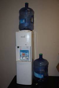 lot 5 image: Primo water dispenser cooler and heater with water jugs