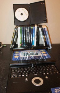 lot 214 image: Teach and Talk learning laptop, and DVD movies