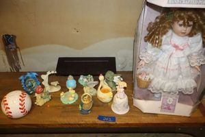 lot 242 image: Porcelain Doll, figurines, ceramic bell and baseball piggy bank