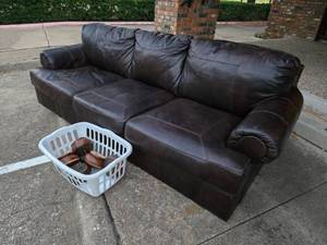 lot 259 image: Brown faux leather sofa couch by Ashley furniture, has 5 removeable round feet