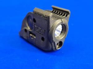 lot 66 image: Streamlight TLR-6 Tactical Pistol Mount FlashlightLaser Combo for Smith & Wesson M&P.  Needs body screw kit.