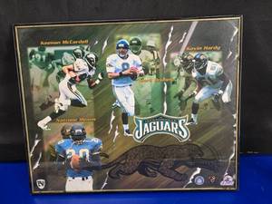 lot 223 image: Inagural Season Jacksonville Jaguars Framed Poster w Banned Logo.  LOOK UP THE PRICE OF BANNED LOGO JAGUARS ITEMS
