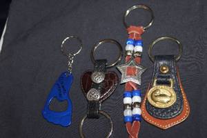 lot 143 image: Four Key chains including Dooney and Burke