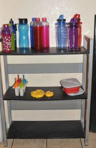lot 158 image: Black and Silver Shelf with Contents