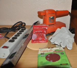 lot 83 image: Black and Decker Orbital Sander, Sanding Discs, Level, Power Strip and More