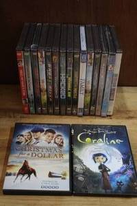 lot 182 image: Lot of DVDs only 2 is open all others are unopened DVDs like nightmare before Christmas, 13 going on 30, guns for hire, Ghost Rider, and many more see pictures