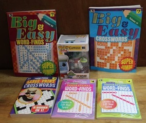 lot 140 image: Mixed Lot of crossword and word find books never used and a unopened cup head pop funk