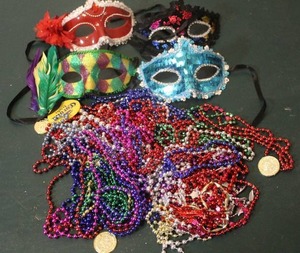 lot 293 image: a collection of Venetian masks and Mardi Gras beads