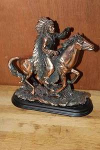 lot 113 image: a bronze sculpture of a Native American chief on horseback, likely inspired by the artwork of Carl Kauba, known for his depictions of the American West