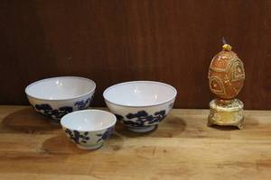 lot 114 image: a decorative, jeweled egg music box the egg spins around as the music plays the bird on top is missing a wing and 3 Chinese blue and white porcelain bowl decorated with the Three Friends of Winter