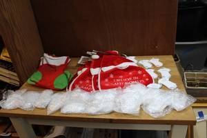 lot 82 image: Lot of babys first Christmas ornaments baby bibs and stockings