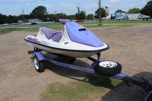 lot 301 image: SeaDoo bombardier and trailer   was told it ran when parked  so may need work I dont know much about them  I dont no if they come with a title but this one doesnt have one the ball on the trailer is a 1- 78