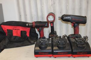 lot 52 image: Snap-on cordless tool set, drill, impack driver, flash light, batteries and storage tote