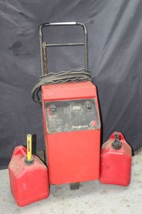 lot 144 image: Snap-On Fast 420 battery jump assistant plus two gas cans
