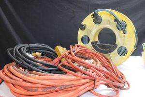 lot 169 image: Assorted extension cords plus cord storage wheel