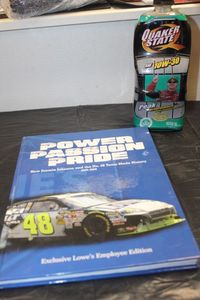 lot 225 image: Power Passion Pride NASCAR book and unique Quaker State car shaped oil bottle