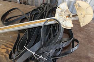 lot 244 image: Assorted automotive fan belts and fan belt tension gauge
