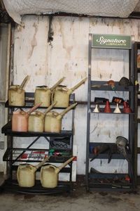lot 320 image: Oil change equipment including oil bottles, funnels and storage racks
