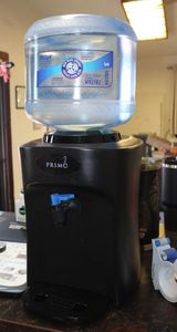 lot 375 image: Primo water dispenser with 3 gallon bottle