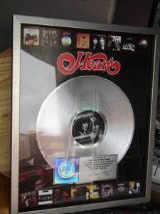 lot 198 image: HEART (NANCY & ANN WILSON)  - RIAA   PLATINUM RECORD  PRESENTED TO LYNDSEY STRATTON  21 X 17 FRAMED - REPRESENTS SALES OF 1 MILLION ALBUMS 1  heart framed Grammy