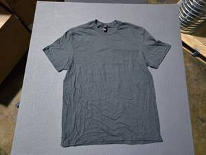 lot 207 image: WOW  2 Boxes of District DT6000 Deepest Grey Cotton Shirts, ,  SEE DESCRIPTION FOR SIZES AND QUANTITIES  BID IS TIMES THE QUANTITY SO YOU ARE BIDDING PER BOX