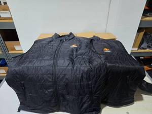 lot 291 image: Lot of 25 Boost Mobile Embroidered Puffer Jackets & Vest.  SEE LAST PIC FOR SIZES & COUNTS