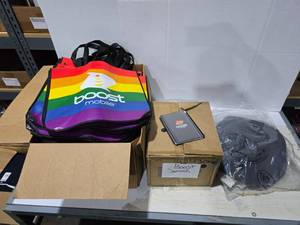 lot 345 image: Large Lot of Misc Boost Mobile Promotional Products.  Includes Pride Bags, Notebooks & Sun Hats