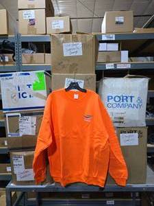 lot 397 image: Large Lot of 9 Boxes of Orange Silver Eagle Distributors Sweatshirts.  Approx 170 Sweatshirts