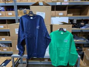 lot 398 image: Large Lot of 6 Boxes of Navy & Green Silver Eagle Distributors Sweatshirts.  Approx 78 Navy & 26 Green