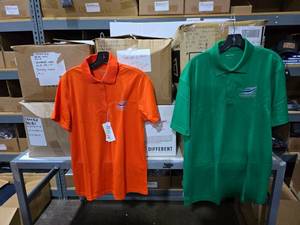 lot 400 image: Large Lot of 6 Boxes of Orange & Green Silver Eagle Distributors Polo Shirts.  Approx 100 Green & 175 Orange