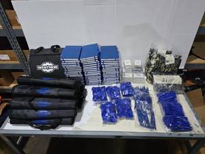 lot 459 image: MASSIVE Lot of Misc Westmor Items.  Includes BBQ Sets (Qty 10), Blanket (Qty 1), Notebooks (Qty 54), Laptop Camera Privacy Clips (Qty 250), Pens (Qty 100), Koozies (Qty 60) & Playing Cards (Qty 18)