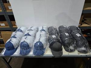 lot 610 image: Large Lot of Outdoor Cap & Yupoong Hats.  Includes Outdoor Cap NavyWhite PDT-750M (9 Packs) & Yupoong 6606 CharcoalBlack (6 Packs).  Approx 12 Hats Per Pack  QUANTITY 15 PACKS TOTAL  BID IS TIMES THE QUANTITY