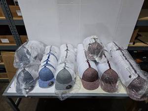 lot 611 image: Large Lot of Pacific 106C Hats.  Includes Heather NavyWhite, Heather RoyalWhite, Heather GreenWhite, Heather MaroonWhite.  Approx 12 Hats Per Pack.  QUANTITY 16 PACKS TOTAL  BID IS TIMES THE QUANTITY