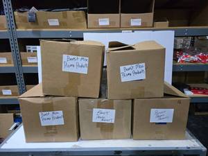 lot 645 image: 5 Boxes of Misc Boost Mobile Promotional Products.  Includes Flags, Buckets, Drawstring Backpacks, Koozies, Phone Holders, Stress Balls, Wireless Charging Mouse Pads, Wireless Earbuds & MORE