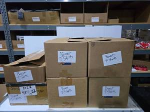 lot 649 image: 6 Boxes of Misc Boost Mobile Shirts.  SEE PICS FOR STYLES