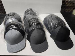 lot 674 image: Richardson 312 Solid Twill Trucker Hats.  Heather GrayBlack, CharcoalBlack & Black Gray.  Approx 12 Hats Per Pack  QUANTITY 5 PACKS  BID IS TIMES THE QUANTITY