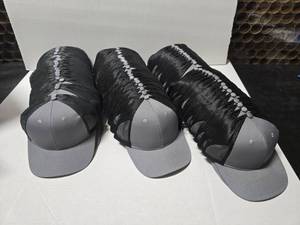 lot 683 image: Port Authority Heather Grey Adjusbtale Trucker Hats.  Approx 12 Hats Per Pack.  Includes GreyGrey (2 Packs) & GreyBlack (4 Packs)  QUANTITY 6 TOTAL PACKS  BID IS TIMES THE QUANTITY