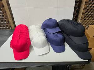 lot 815 image: Lot of Port & Company Hats.  Red, White, Navy & Black.  Approx 12 Hats Per Pack  QUANTITY 10 PACKS  BID IS TIMES THE QUANTITY