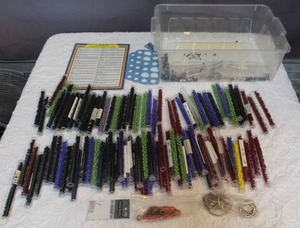 lot 56 image: Tote full of tubes of glass Druk beads.